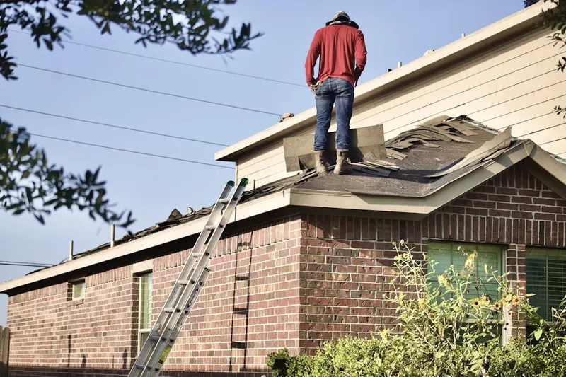 Professional roofer working on a residential roof in Starwood